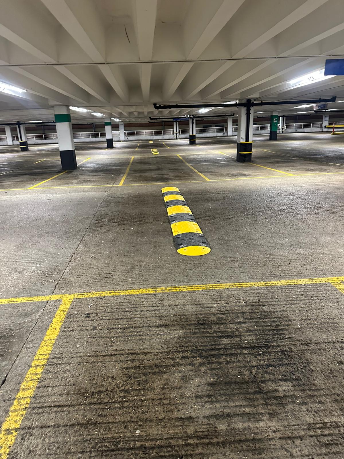 Indoor car park speed hump aligned with painted lane markings
