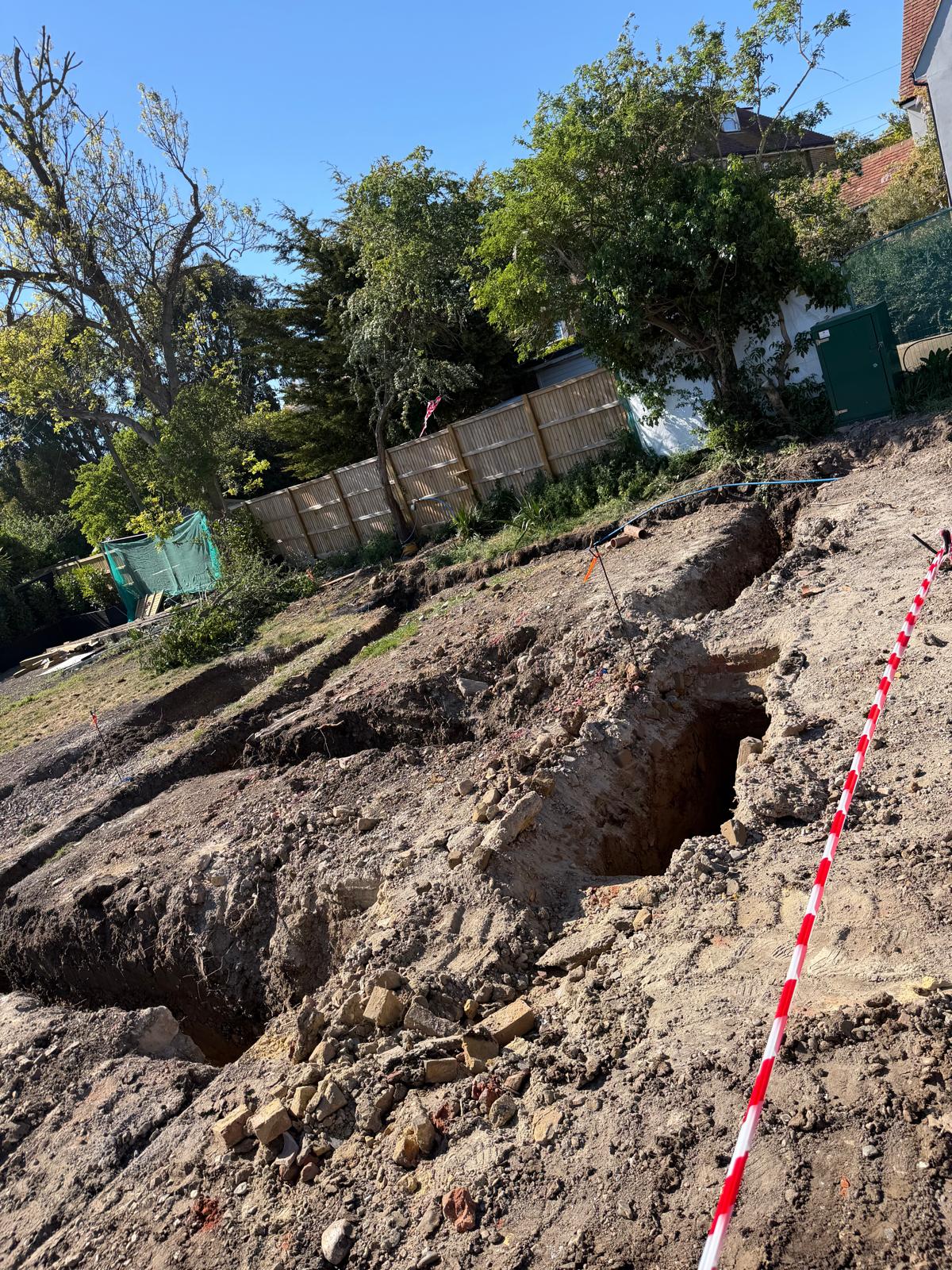 Wide view of foundation trenches cut through made ground ready for concrete