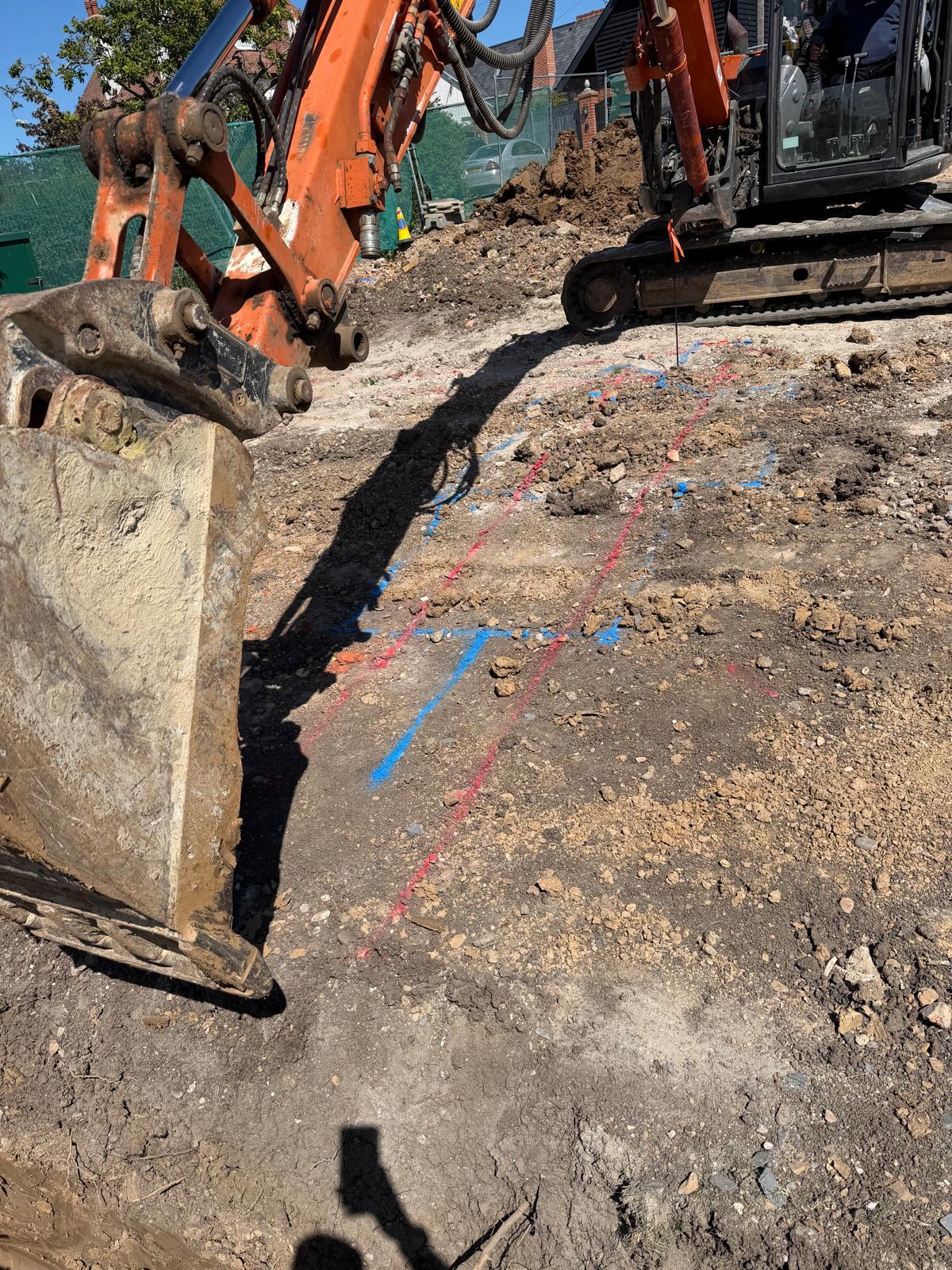 Intersecting foundation trenches prepared for new structural concrete