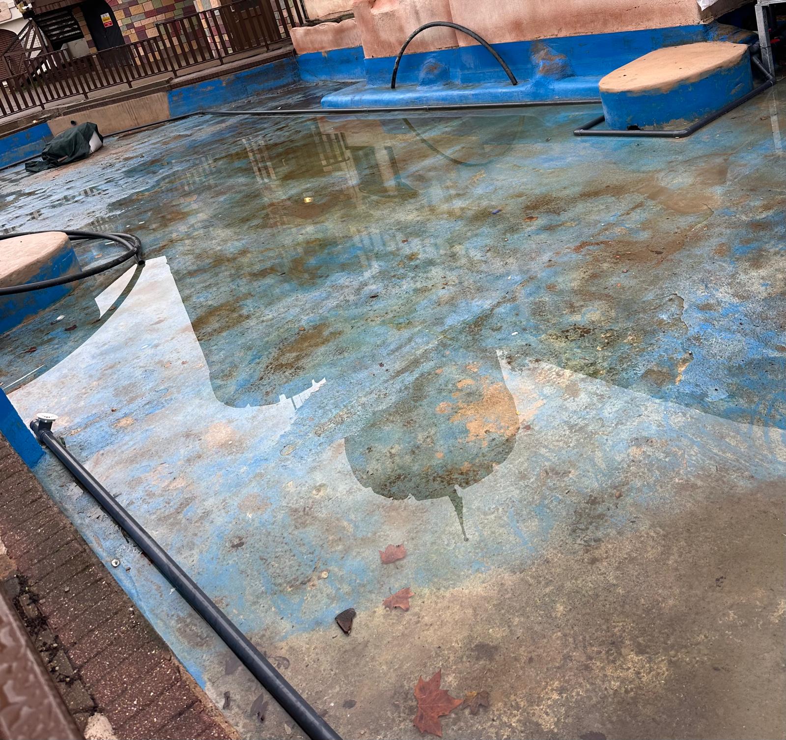 Part-renovated commercial pond showing remaining stained coating prior to the final coat