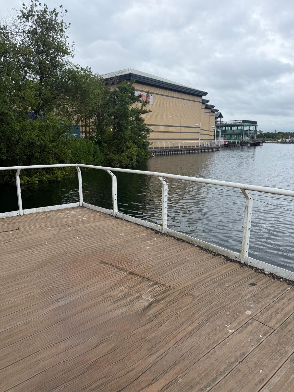 Commercial waterside walkway railing before safety cable reinstatement