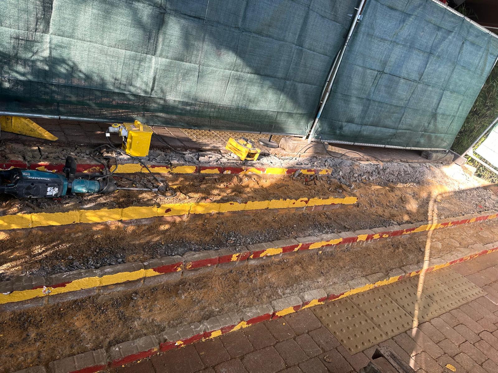 Commercial brick stairs stripped out with yellow nosings exposed during repair