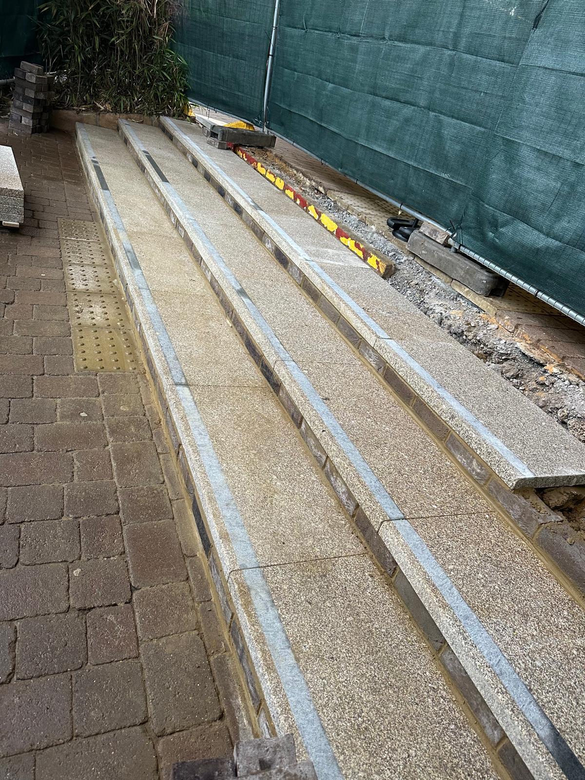 Commercial stair repair: new stone treads, brick risers and tactile paving