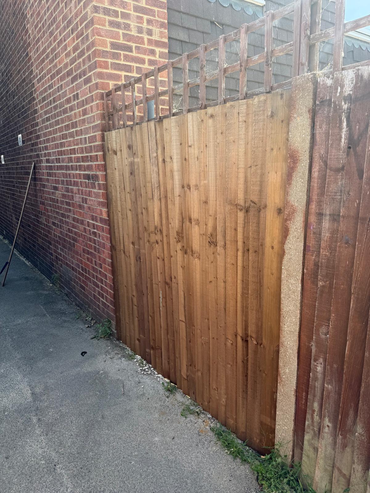 Replacement closeboard-style fence panel fitted to a garden side-return boundary