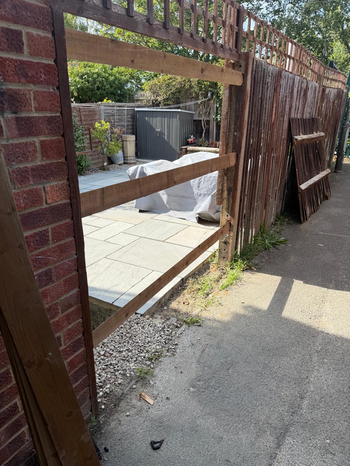 Garden boundary before the new fence panel, with old slats removed from the posts