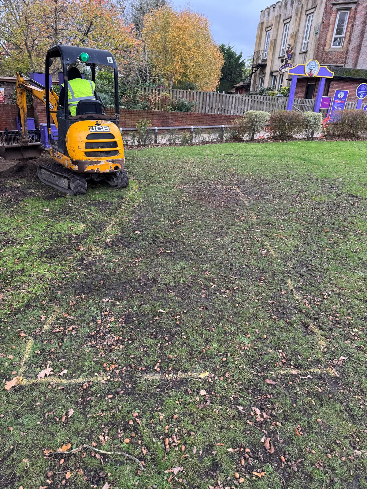 JCB mini digger and spray-marked grass setting out a second public footpath spur