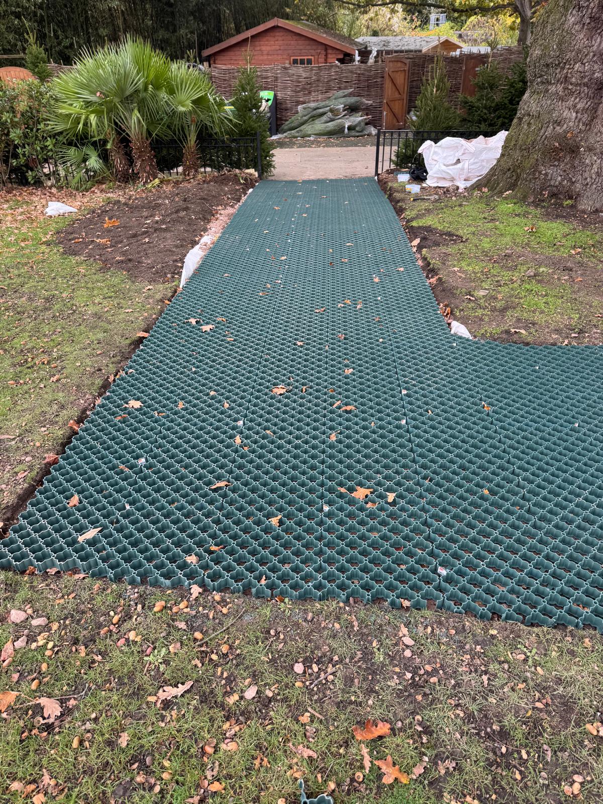 Completed run of interlocking grass grid tiles forming a reinforced public footpath