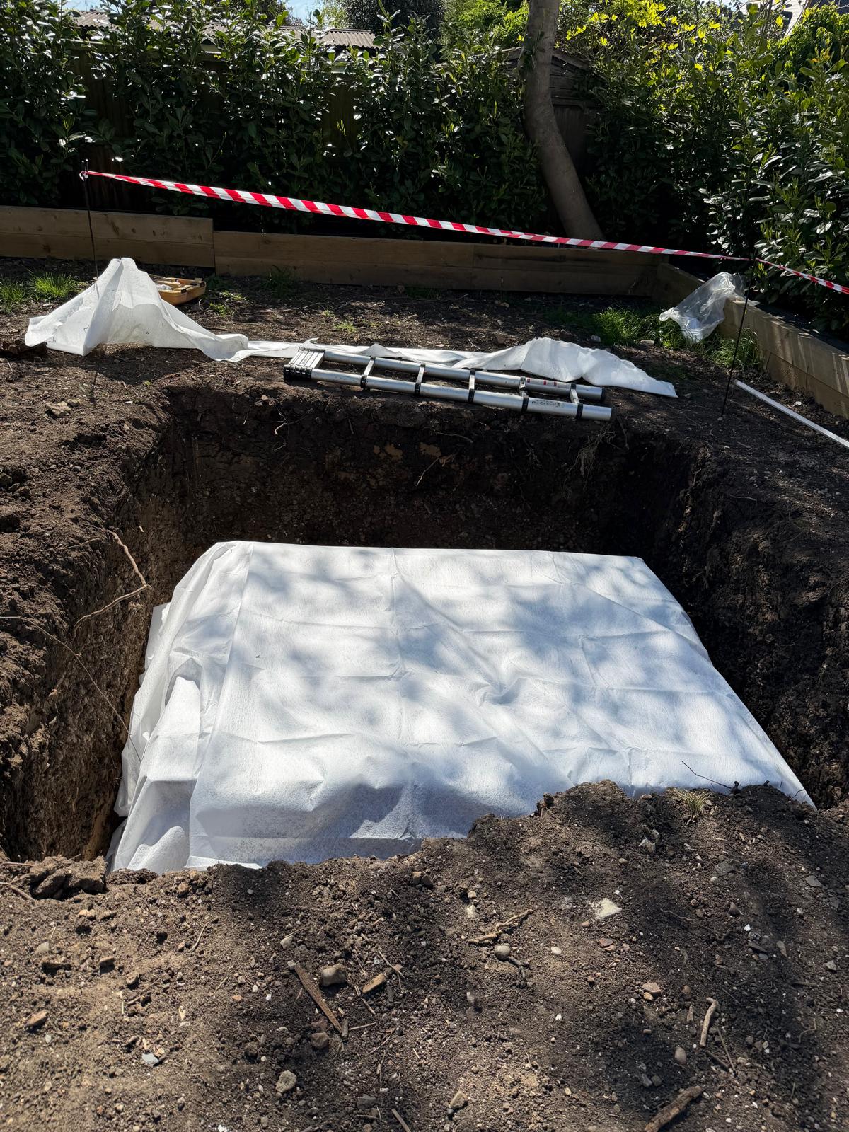 Geotextile membrane lining a soakaway excavation before crates are installed