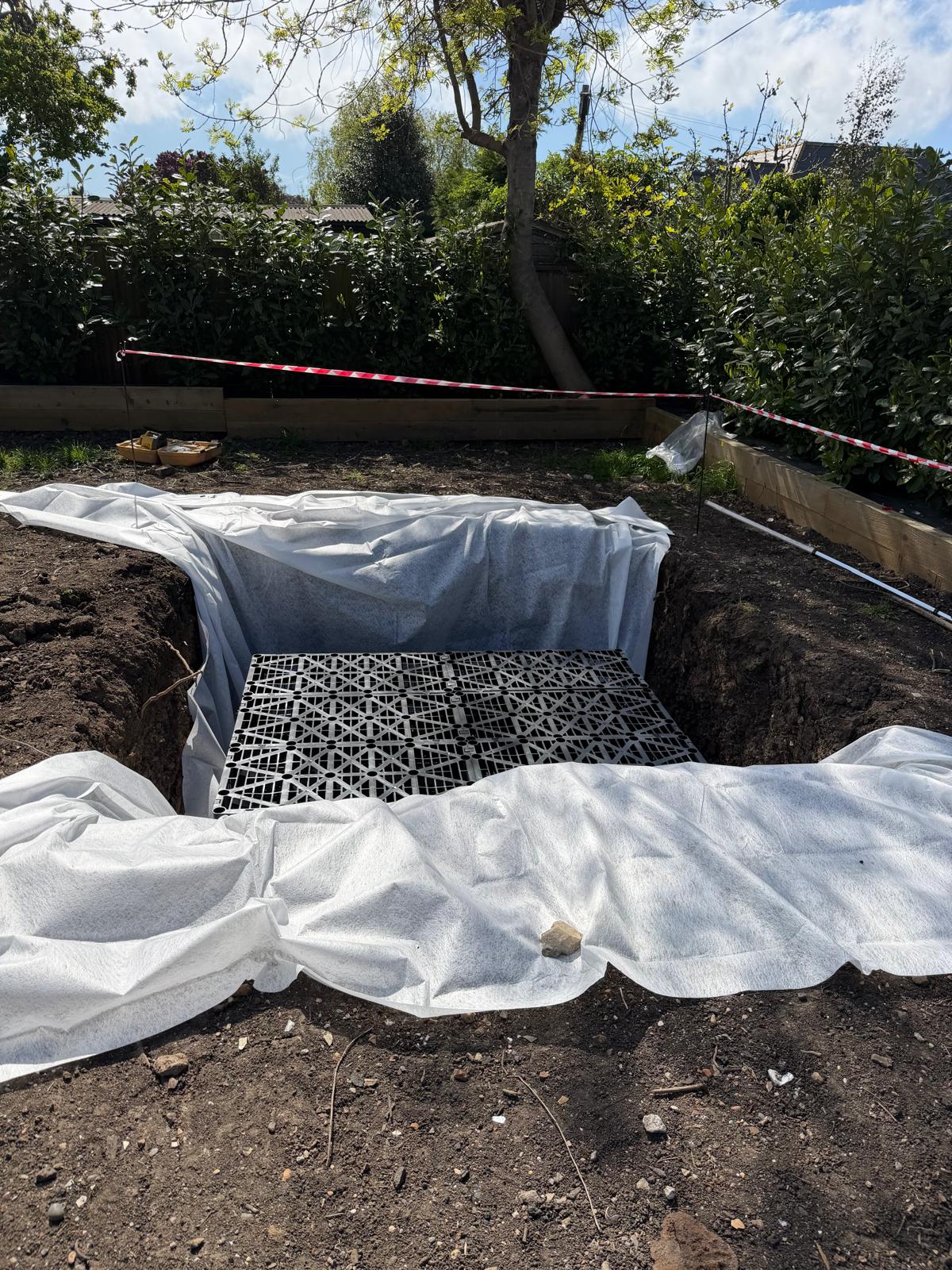 Garden soakaway installation: crate system, geotextile and drainage groundworks
